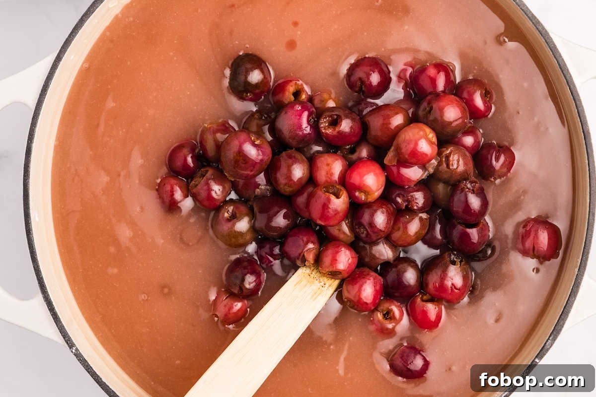 Homemade Cherry Pie Filling for Water Bath Canning: Step-by-Step Guide 8 cherries added to syrup in pot.