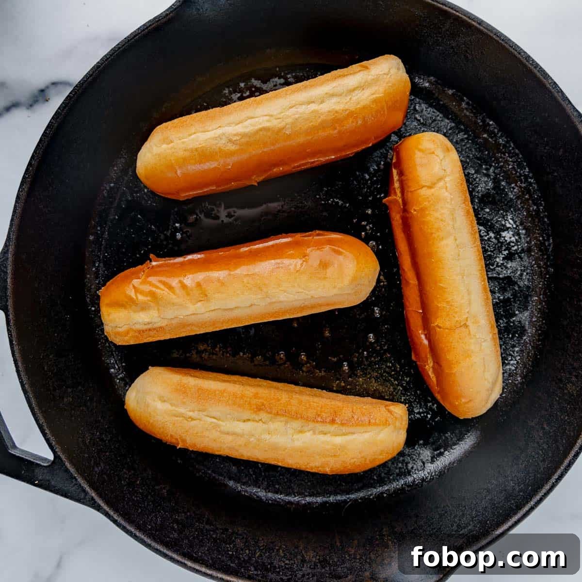 Classic Maine Lobster Roll Recipe: How to Make Authentic Lobster Rolls 8 Hot dog buns in a cast iron skillet.