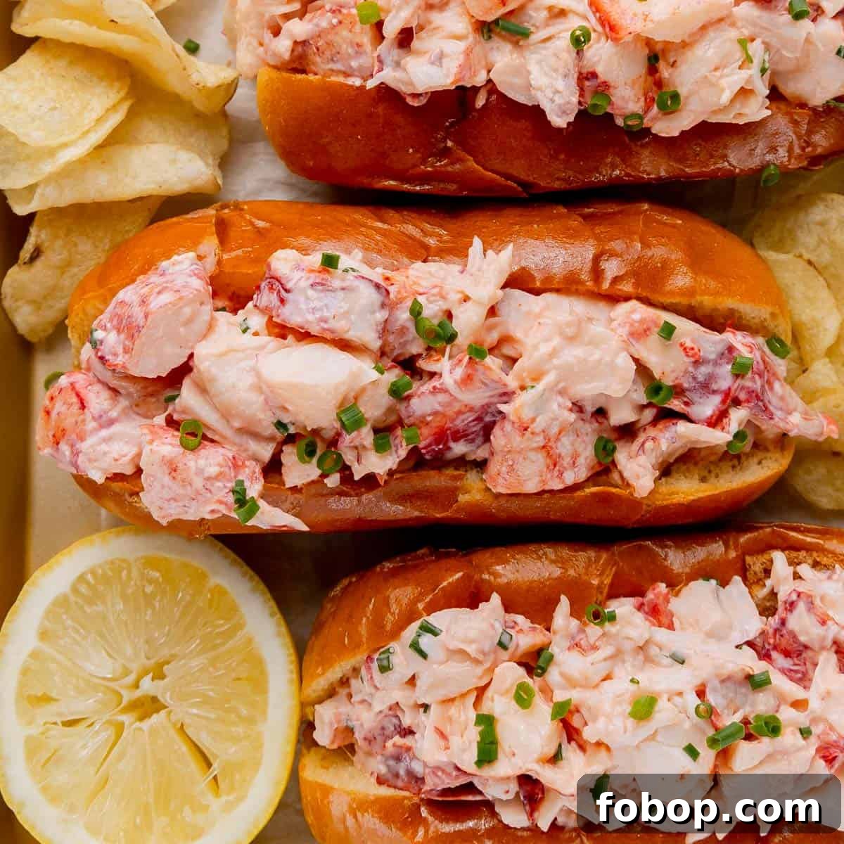Classic Maine Lobster Roll Recipe: How to Make Authentic Lobster Rolls 10 Three Lobster rolls with chips and lemon.