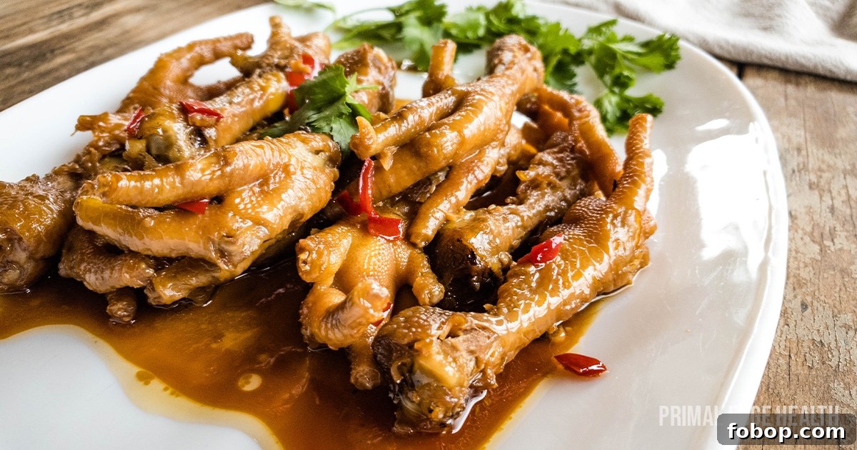 13 Delicious Low-Carb Snacks That Beat Potato Chips 12 Chicken adobo feet one white plate with cilantro garnish.