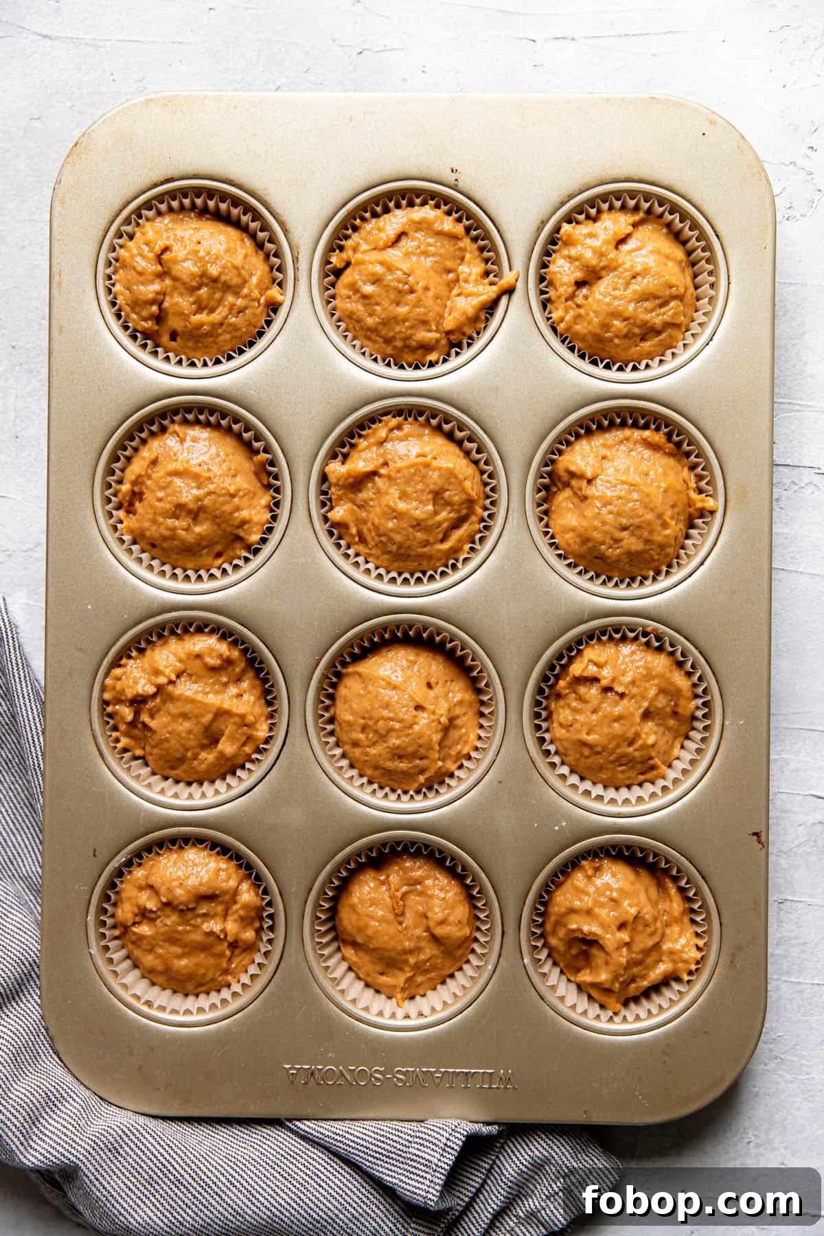Moist Pumpkin Muffins with Warm Spices — Simple Fall Recipe 6 pumpkin muffins before baking in a muffin tin.