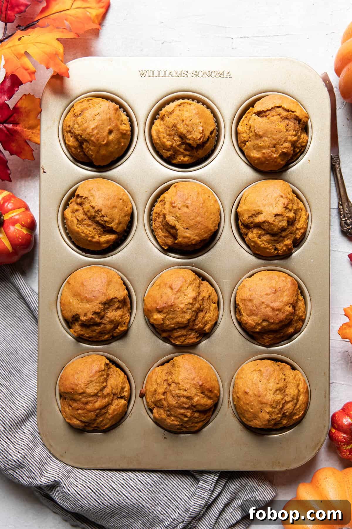 Moist Pumpkin Muffins with Warm Spices — Simple Fall Recipe 7 pumpkin muffins in a muffin tin.
