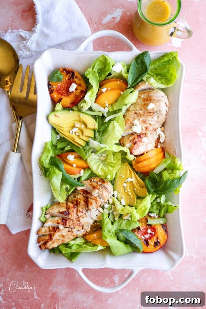 Grilled Peach and Avocado Chicken Salad with Honey-Lime Dressing 2 grilled peach avocado chicken salad on white platter