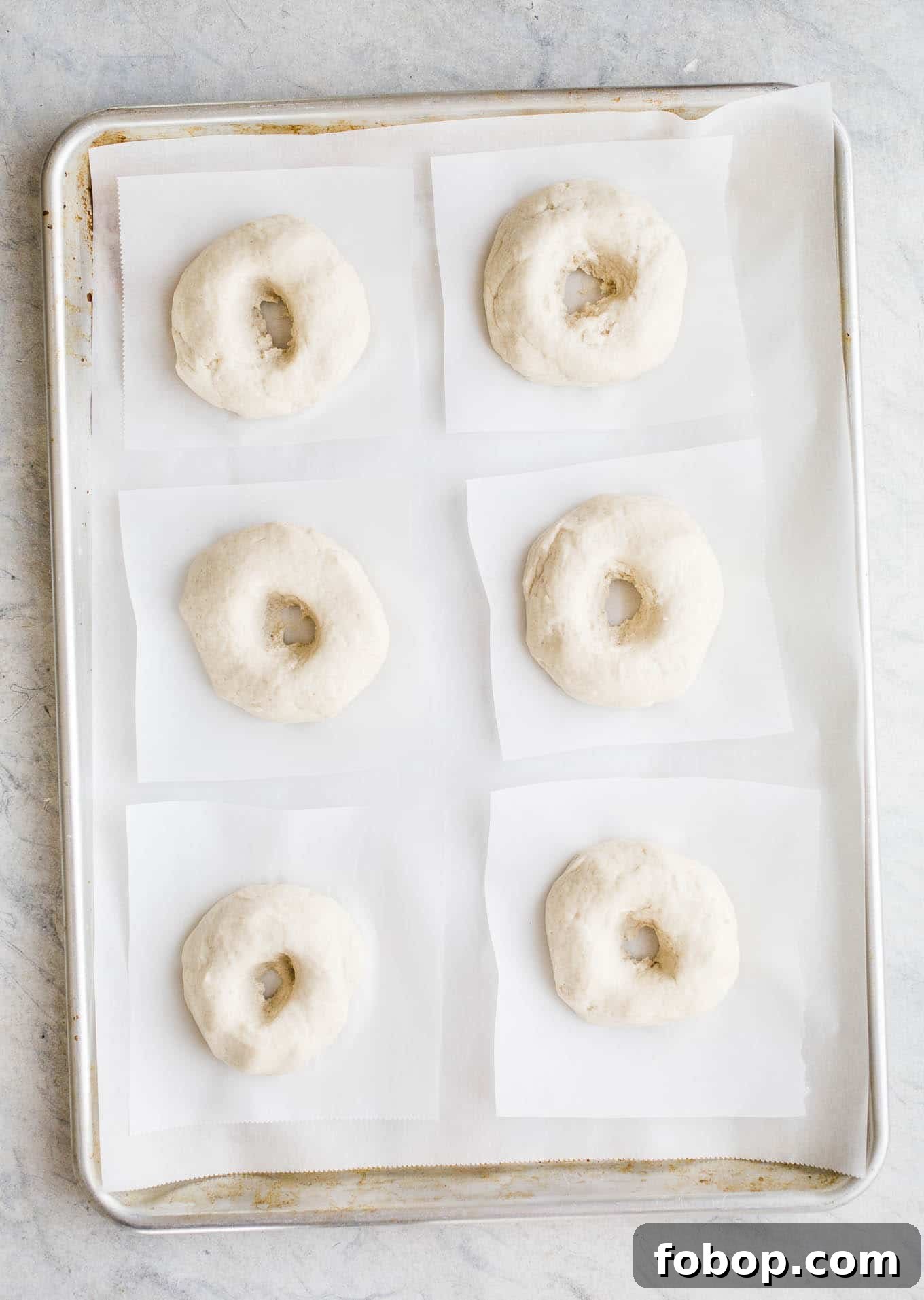 Vegan Gluten-Free Bagel Recipe: Soft Homemade Bagels 3 Proofed bagels on a baking sheet.