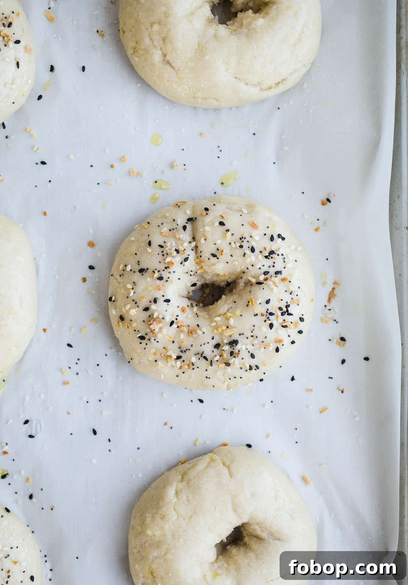 Vegan Gluten-Free Bagel Recipe: Soft Homemade Bagels 4 Unbaked bagels with seeds on top.