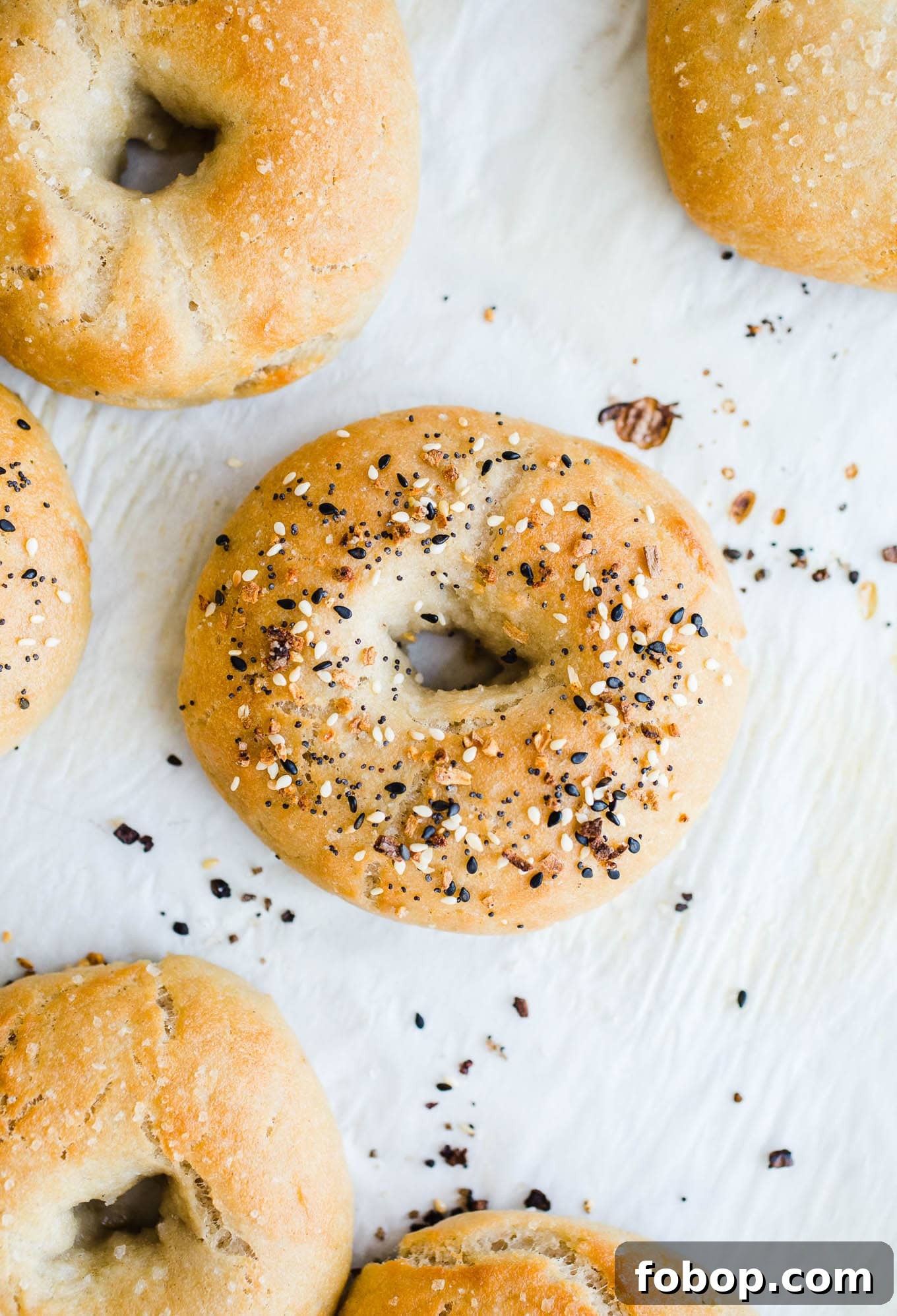 Vegan Gluten-Free Bagel Recipe: Soft Homemade Bagels 5 Baked bagels on a baking sheet.