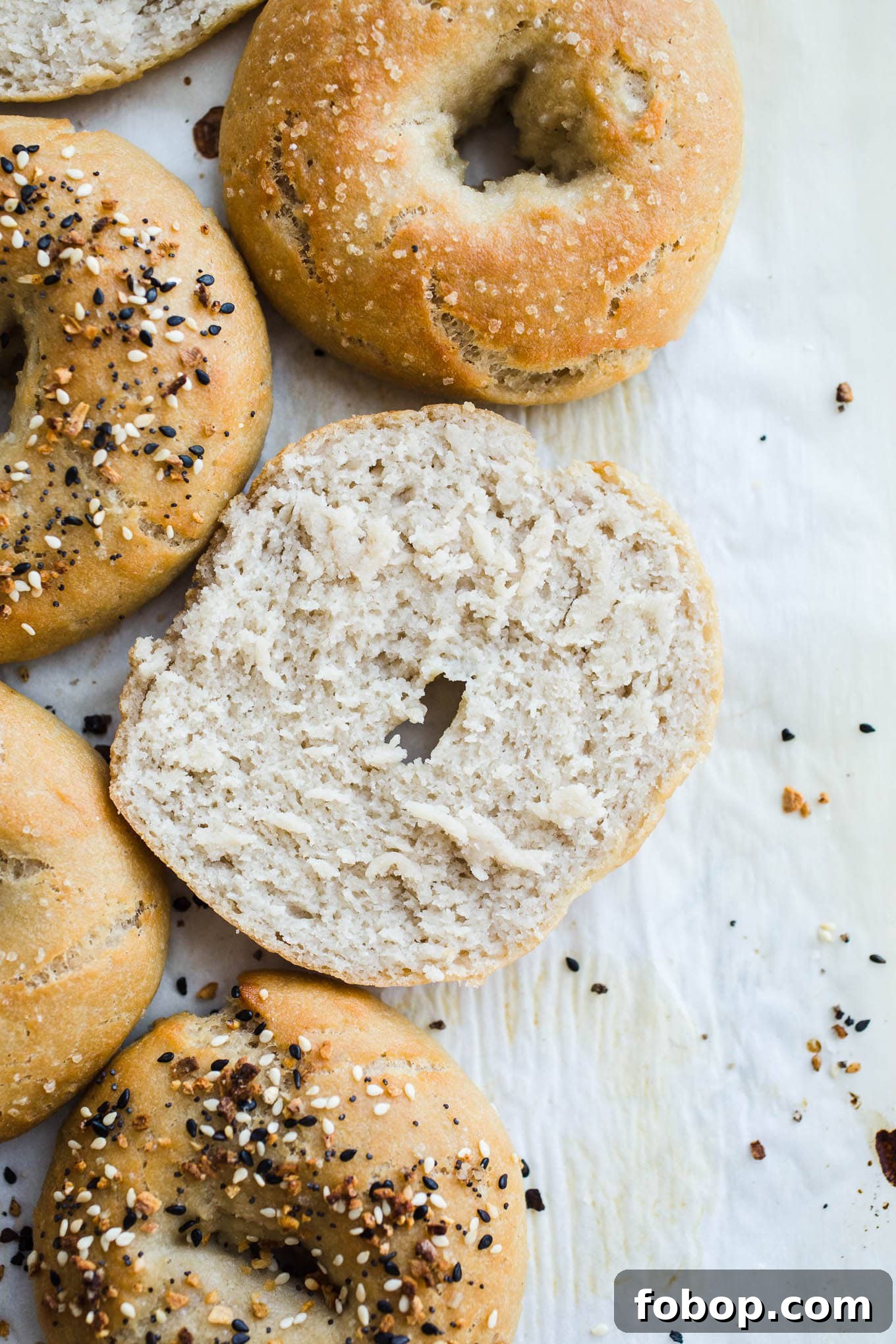 Vegan Gluten-Free Bagel Recipe: Soft Homemade Bagels 6 Sliced bagels on parchment paper.