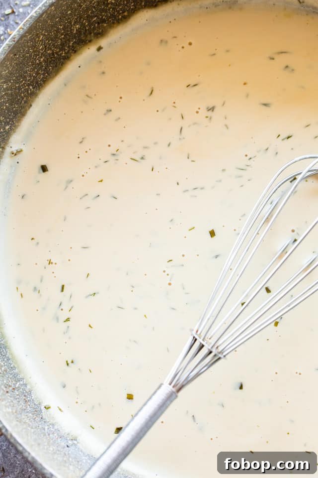 Juicy Instant Pot Pork Chops with Garlic Herb Sauce 2 Whisking a creamy Ranch Sauce in the Instant Pot.