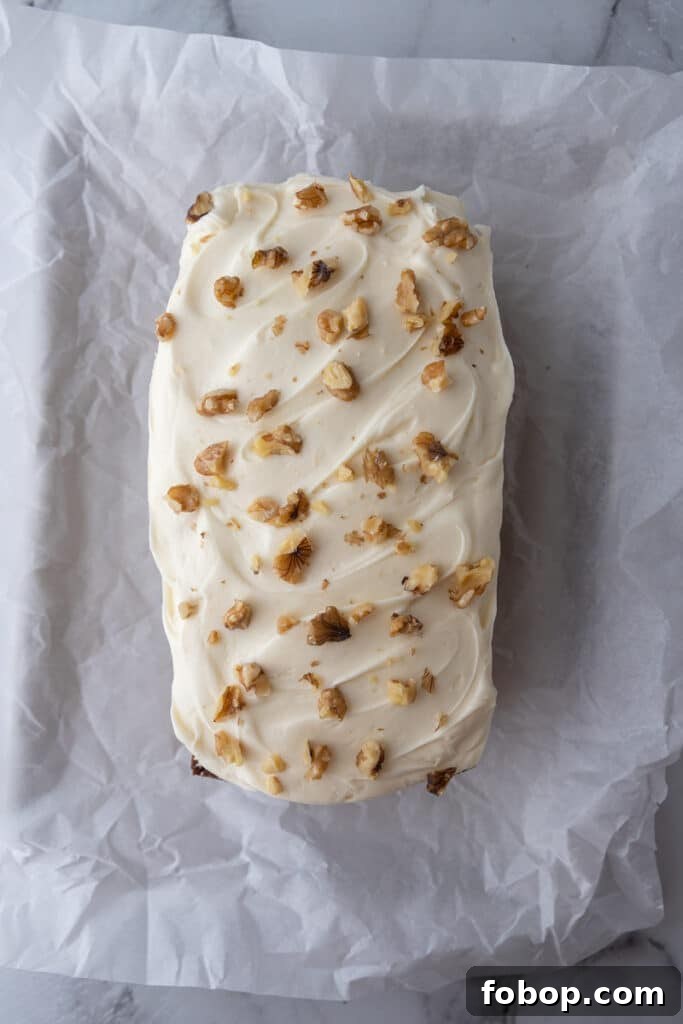 Moist Carrot Loaf Cake Recipe with Oil (Loaf Pan Method) 11 Carrot loaf cake topped with thick cream cheese frosting and chopped walnuts