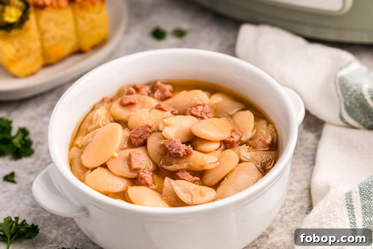 Creamy Slow Cooker Lima Beans Recipe for Weeknight Dinners 6 slow cooker lima beans in a white bowl.