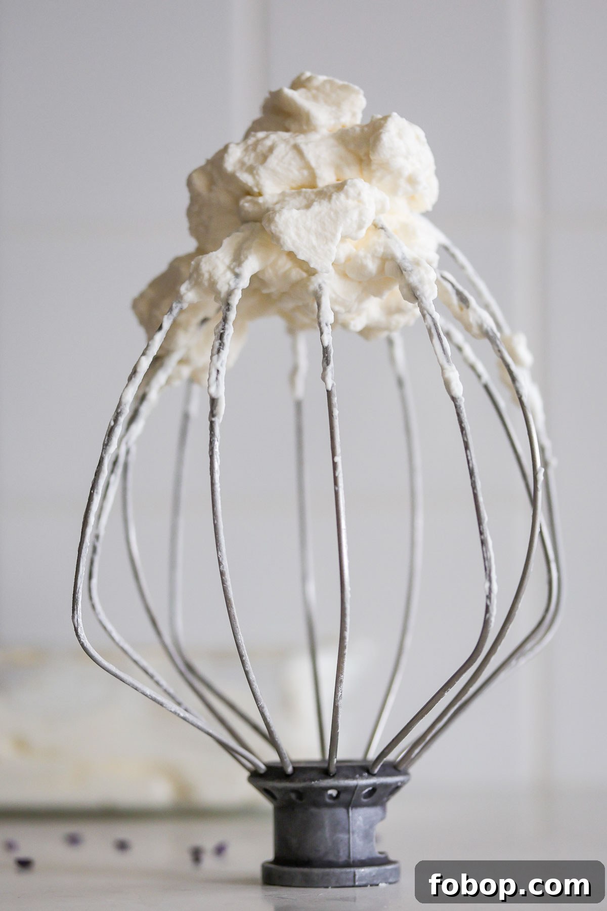 Lavender Whipped Cream Recipe: Light Floral Dessert Topping 2 Whisk with lavender whipped cream.
