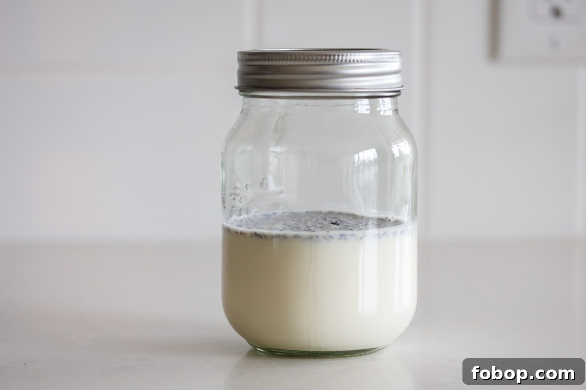Lavender Whipped Cream Recipe: Light Floral Dessert Topping 4 A glass jar with heavy cream and lavender, lid on.
