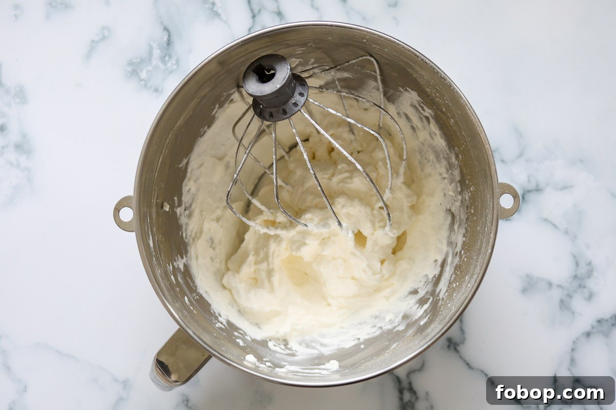 Lavender Whipped Cream Recipe: Light Floral Dessert Topping 6 Lavender whippeed cream, whisk attachment, in a metal bowl.