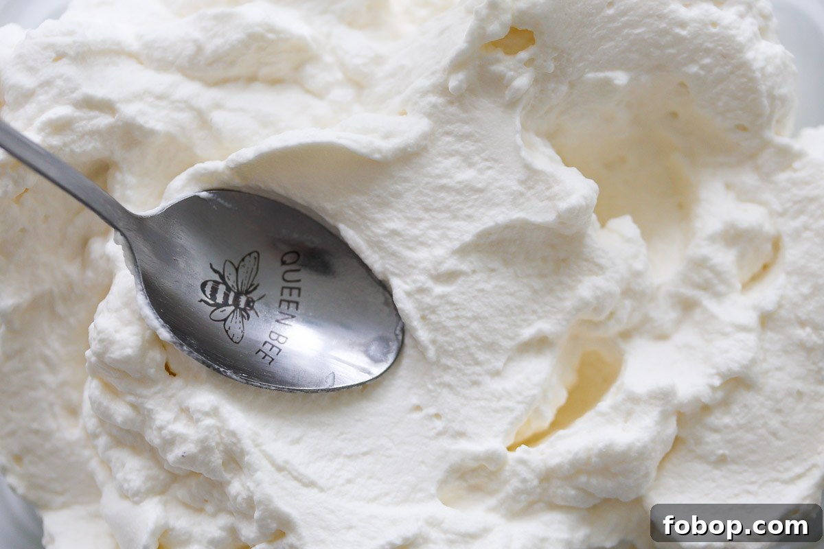 Lavender Whipped Cream Recipe: Light Floral Dessert Topping 8 Lavender whipped cream and metal spoon.