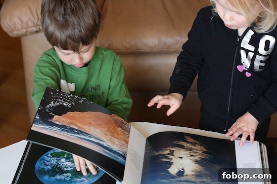 Preschoolers looking at Planet Earth coffee table book