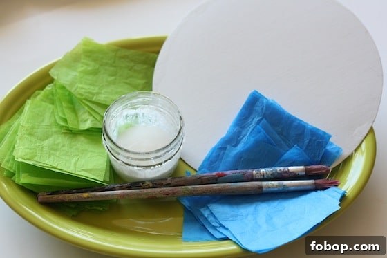green and blue tissue paper, paintbrushes and glue