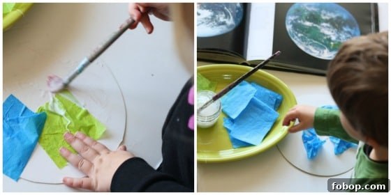 Kids gluing green and blue tissue paper to cardboard circle