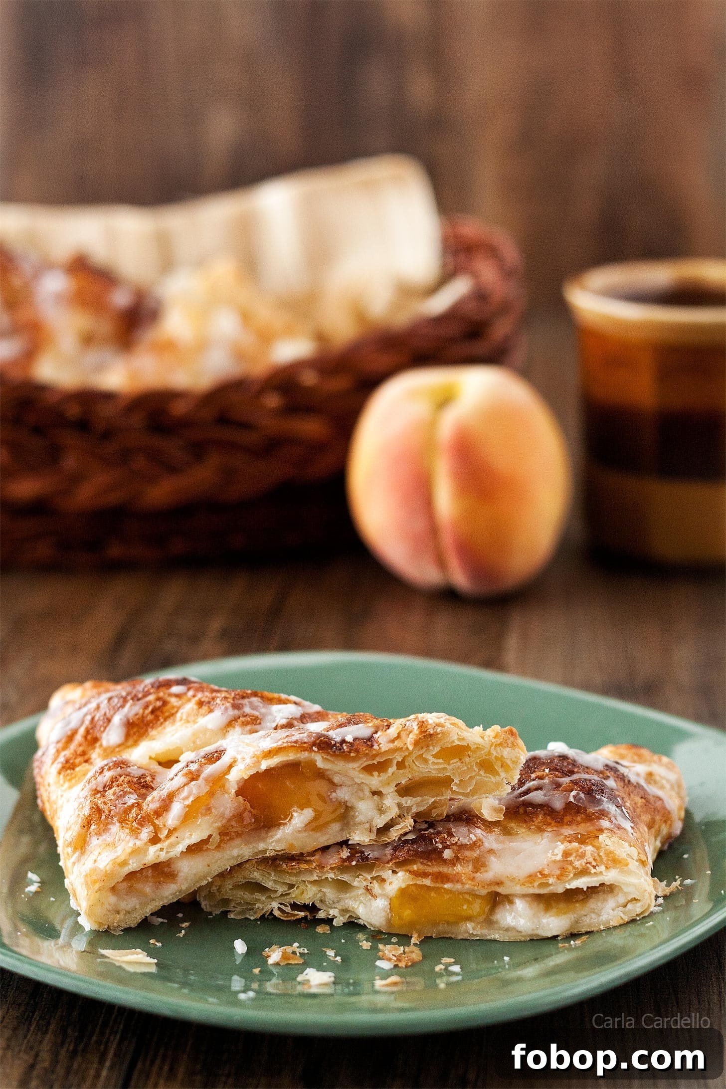 Peach Turnovers with Flaky Puff Pastry Recipe 2 Puff Pastry Peach Turnovers cut in half on a green plate