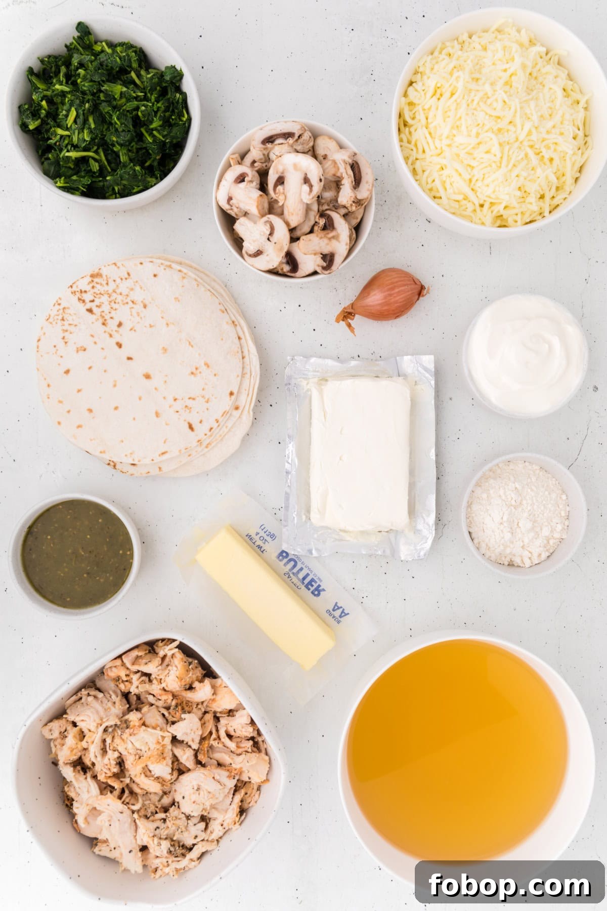 Ingredients for Creamy Chicken Spinach and Mushroom Enchiladas ingredients displayed for making creamy chicken spinach and mushroom enchiladas