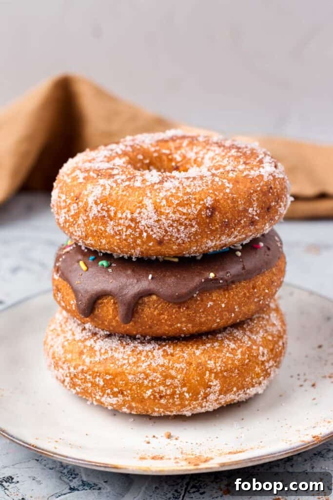 Gluten Free Donuts (Fried, Bakery Style) stacked on top of each other with chocolate frosting and sugared outsides