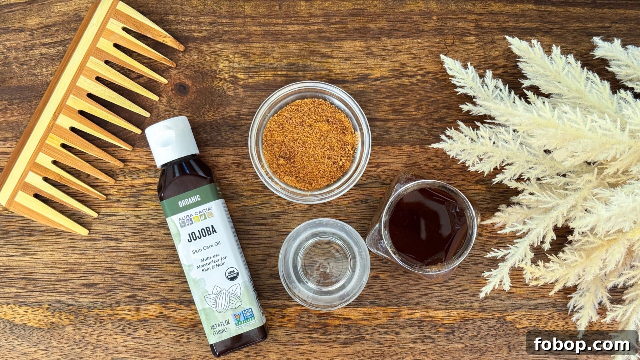 Ingredients for simple scalp scrub including jojoba oil, coconut sugar