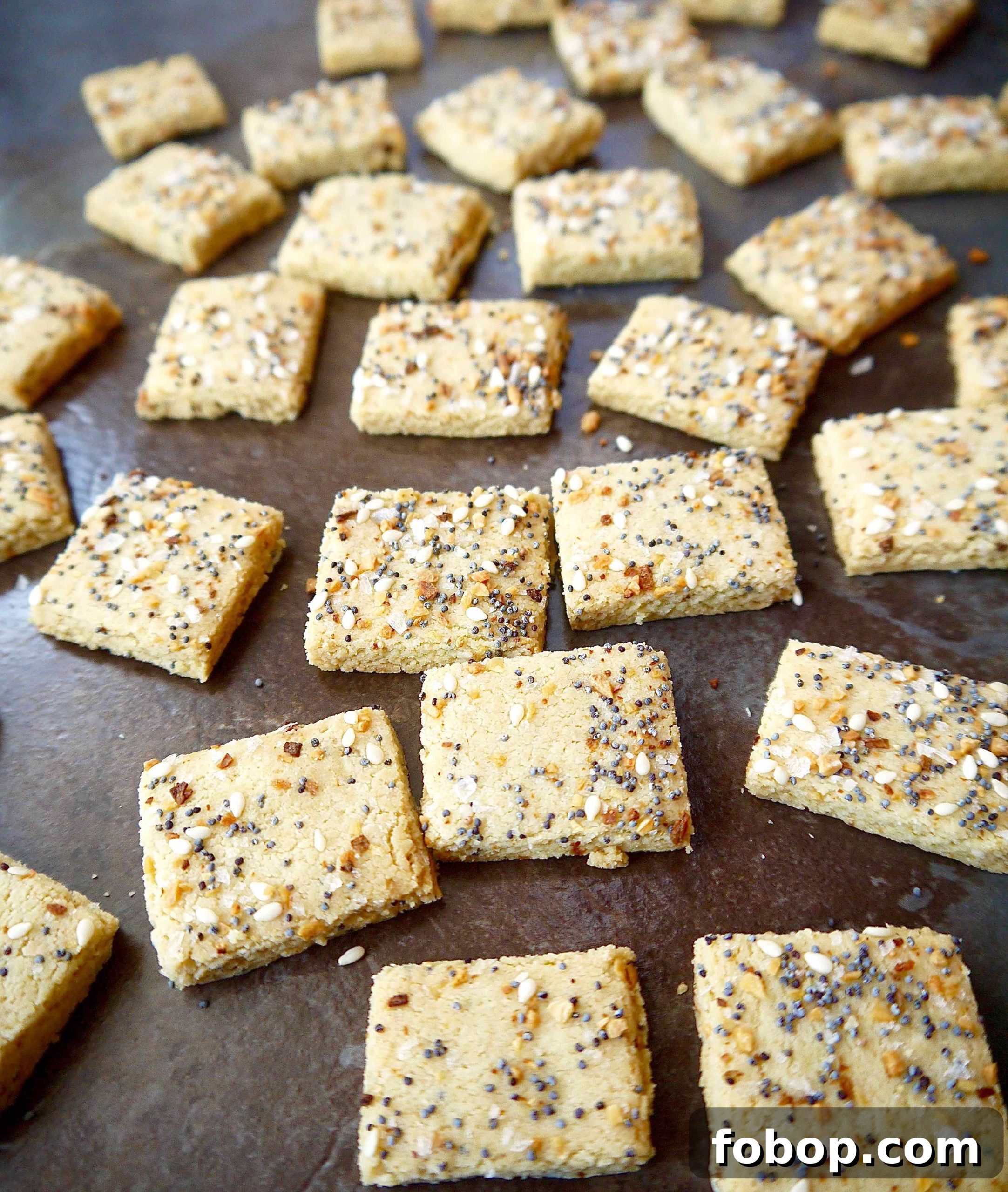 Almond flour cracker dough cut into squares after baking.