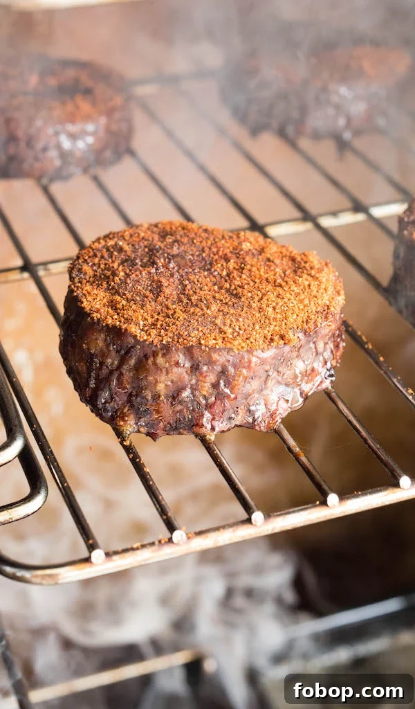 Smoked Hamburgers and Hot Dogs: Classic Backyard Grill Recipe 3 Smoked Hamburger patties on a rack in a smoker.