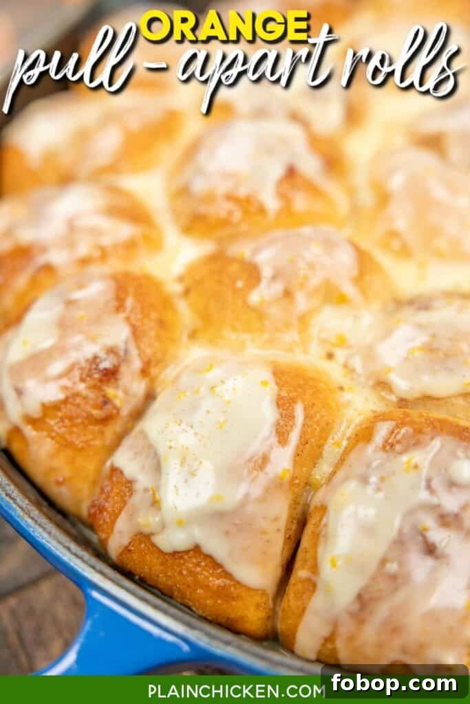 Citrus-Glazed Orange Pull-Apart Dinner Rolls 8 orange rolls in a skillet with text overlay