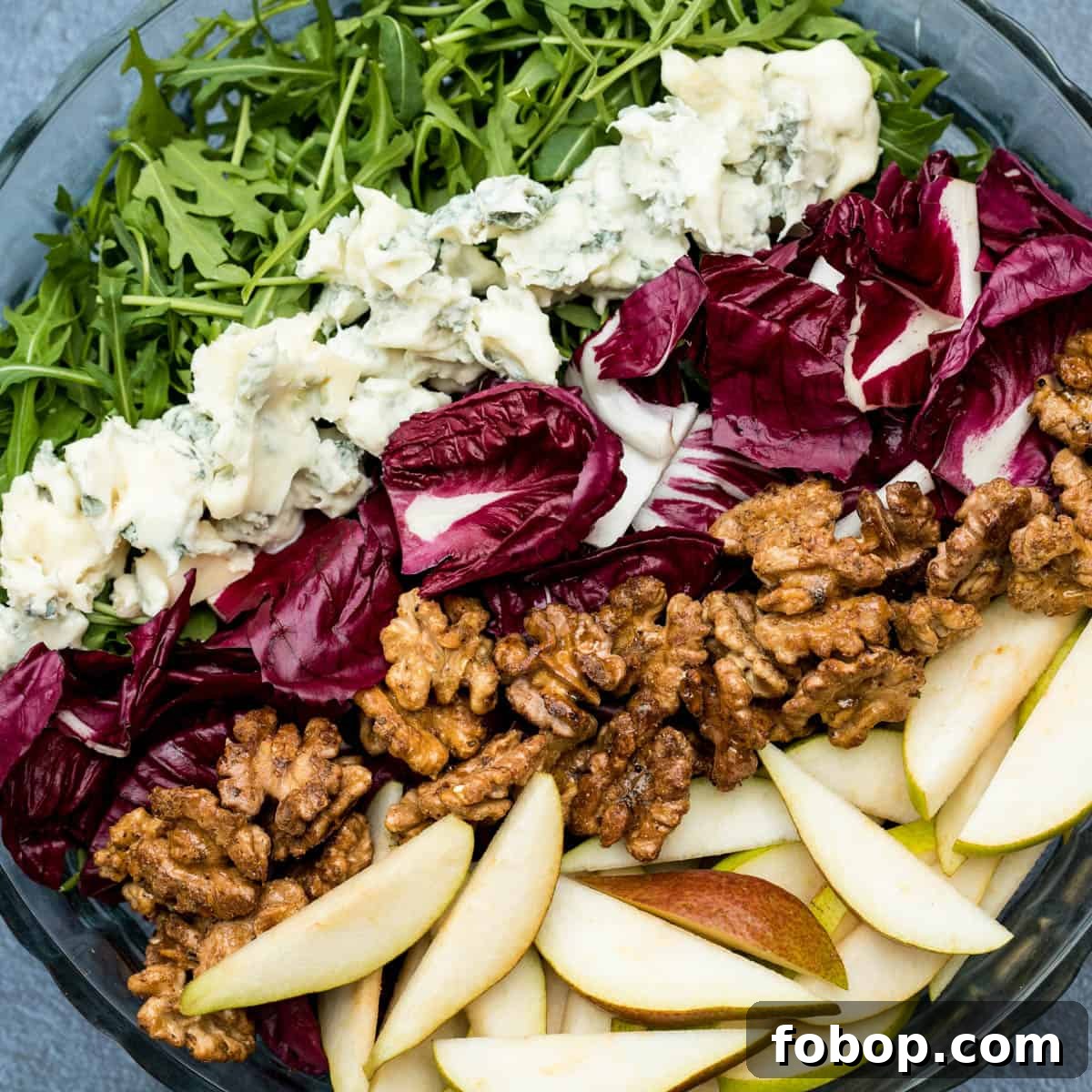 arugula salad with pears, gorgonzola, radicchio, and glazed walnuts.