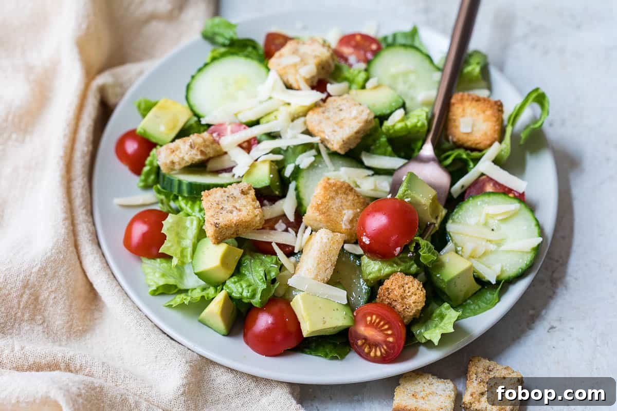 Perfect Side Salad Recipes to Complement Any Meal 8 plate with a side salad with a fork next to a linen napkin.