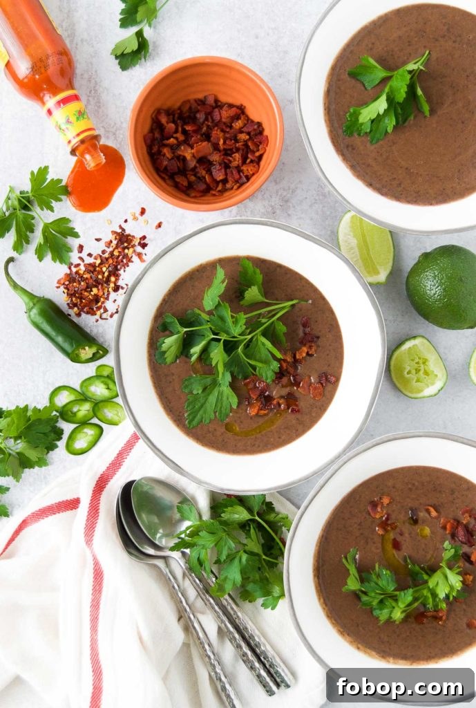 Creamy Black Bean Soup with different toppings.
