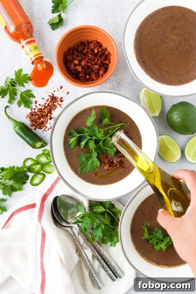 Drizzling olive oil on Creamy Black Bean Soup