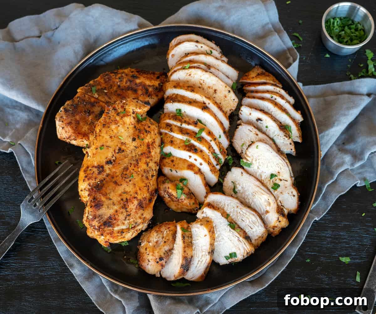 platter of grilled chicken breasts sliced.
