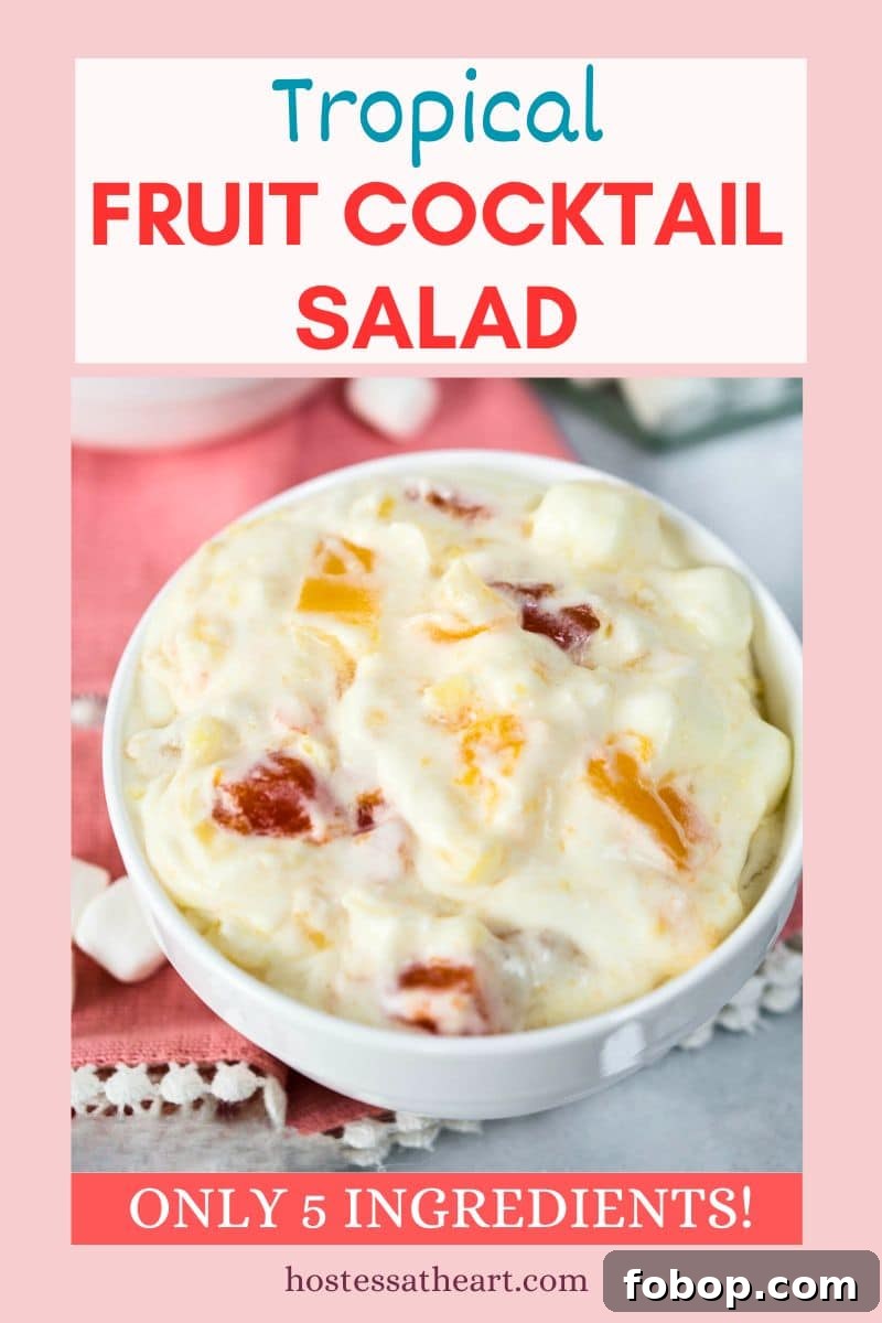 Image for Pinterest of a bowl of fruit cocktail salad made with whipped topping and pudding - Hostess At Heart